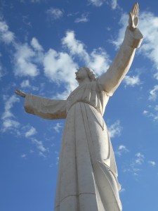 every day with arms out stretched above the  disaster site