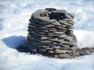 skipping stones gathered into a circle next to Cayuga Lake