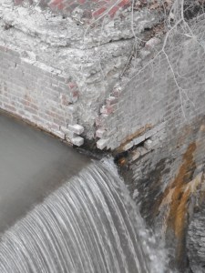at the corner the brickwork of the dam