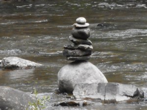 mid-stream the stones are in a balancing act