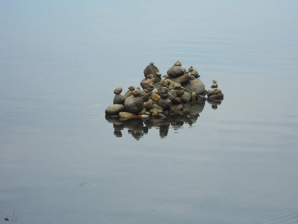 still waters with stone piles
