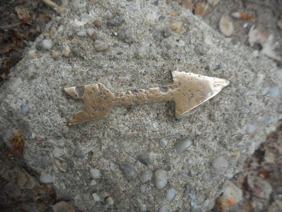 n Central Park a little brass arrow pointing the way from another era... it was not clear what way it was pointing at but I liked the well worn aspect, especially the tip of the arrow...