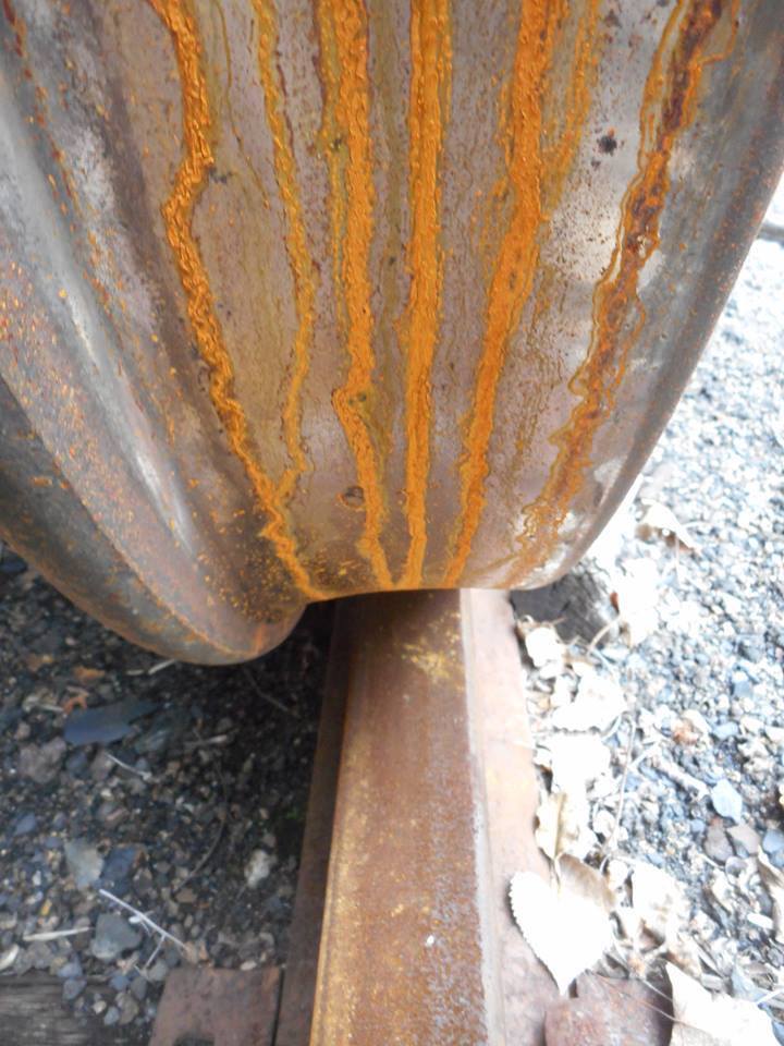 train wheel at rest with rust rivulets